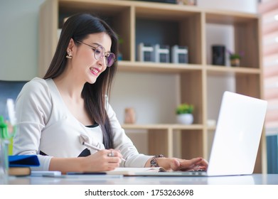 Beautiful Asian Businesswoman Working With A Laptop In The Office