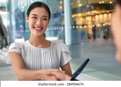 Beautiful Asian Chinese Business Woman Shaking Hands In Modern City Work Office