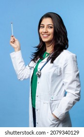 Beautiful Asian Doctor Lady pointing with pointer on copy space, studio shot. Isolated on a gray background. Medical student general practitioner - Shutterstock ID 2079340129