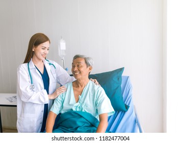 Beautiful Asian Doctor Taking Care Of Senior Patient In Hospital Bed