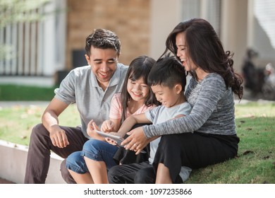 Beautiful Asian Family And Kids Using Tablet Pc Outdoor