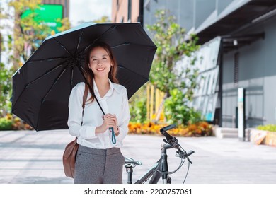 Beautiful asian female business woman use umbrella protect uv, Walk enjoy smiling while doing commuting in the modern city near office building outside