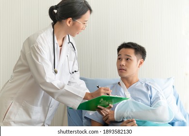 Beautiful Asian Female Doctor And Broken Arm Patient Discussing Current Health Examination In Hospital Room. Medical Service Concept. 