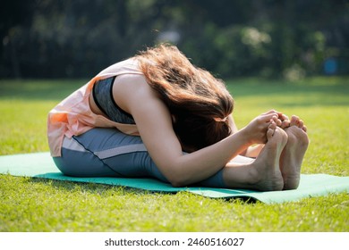 Beautiful asian female doing Seated forward bend exercise,Paschimottanasana pose
 - Powered by Shutterstock