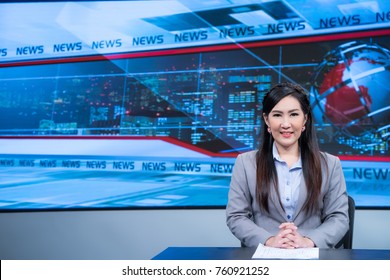 Beautiful Asian Female News Anchor In Studio At Broadcast Room