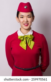 Beautiful Asian Flight Attendant On Grey Background