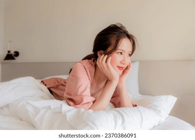 A beautiful Asian girl, bright, sleeping at night, waking up in the morning, doing activities on the bed portrait Asian woman in the bedroom and bathroom activities - Powered by Shutterstock