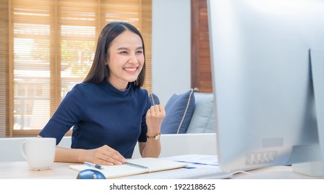 Beautiful asian girl celebrate with laptop computer. Success happy pose. E-commerce. University education. Internet technology. Startup small business concept. Modern office or living room
