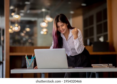 Beautiful Asian girl celebrate with laptop, success happy pose. E-commerce, SME,university education, internet technology, or startup small business concept.