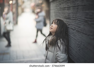 Beautiful Asian Girl Looking Up On Street,Gion Kyoto Japan