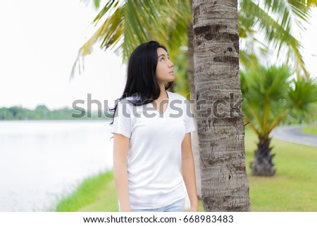Beautiful Asian girl in the park and looking up to the sky
