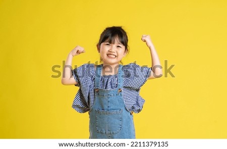 beautiful asian girl portrait, isolated on yellow background