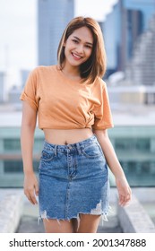 Beautiful Asian girl posing in trendy outdoor on deck in summer.