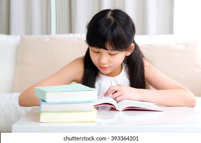 Beautiful Asian Girl Reading Book At Home