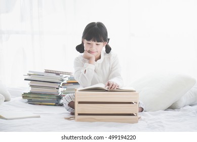 Beautiful Asian Girl Reading A Book Under Sunlight