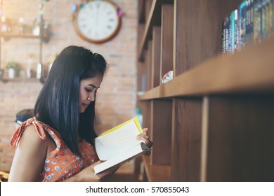 Beautiful Asian Girl Reading Book At Library