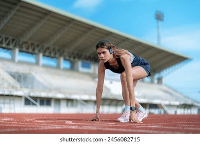 Beautiful Asian girl running at outdoor treadmill in sports stadium, Taking care of health and exercise for modern teenagers. - Powered by Shutterstock