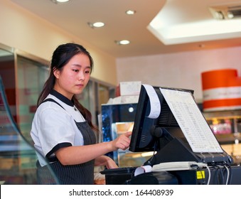 beautiful asian girl seller in the coffee shop - Shutterstock ID 164408939