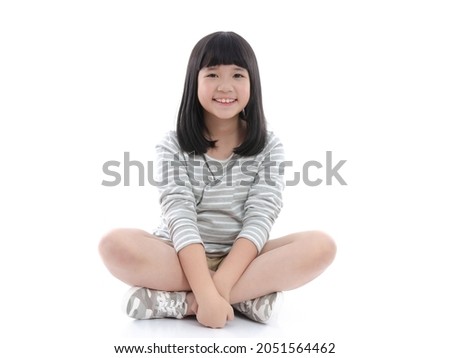 Beautiful asian girl sitting on white background isolated