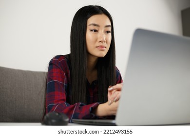 Beautiful Asian Girl Studying On Laptop. Young Vietnamese Woman Working On Notebook Computer At Home