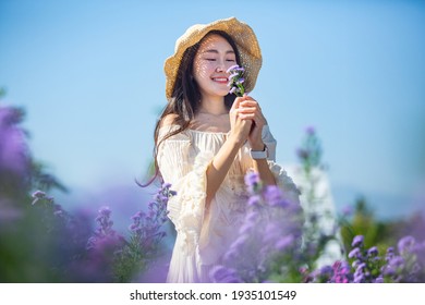 Beautiful Asian Girl Taking Pictures In A Flower Farm. Happily In Chiang Mai, Thailand