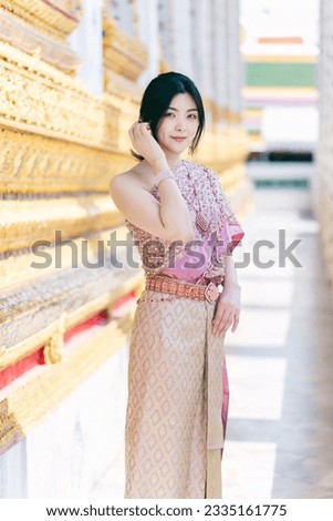 Beautiful Asian girl in Thai traditional costume at temple
