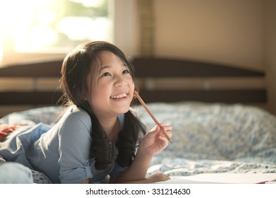 Beautiful asian girl thinking on the bed