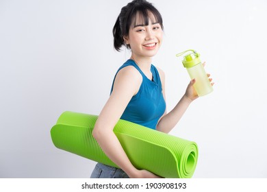 Beautiful Asian Girl Wearing Yoga Suit On White Background
