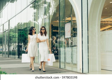 Beautiful Asian Girls With Shopping Bags Walking On Street At The Mall