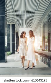 Beautiful Asian Girls With Shopping Bags Walking On Street At The Mall