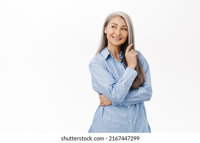 Beautiful Asian Lady, Senior Woman With Grey Hair, Good Facial Skin, Smiling And Looking Happy At Camera, Standing Over White Background