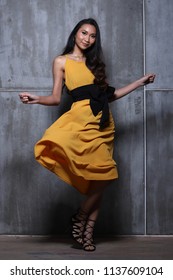 Beautiful Asian Long Straight Black Hair Tan Skin Woman In Yellow Dress Skirt High Fashion Beautiful Asian Long Straight Black Hair Tan Skin Woman In Yellow Dress Skirt High Fashion