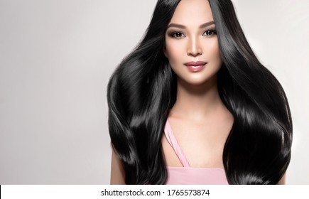 Beautiful asian model girl with shiny black and straight long hair . Keratin straightening . Treatment, care and spa procedures for hair . Chinese girl with smooth hairstyle - Shutterstock ID 1765573874