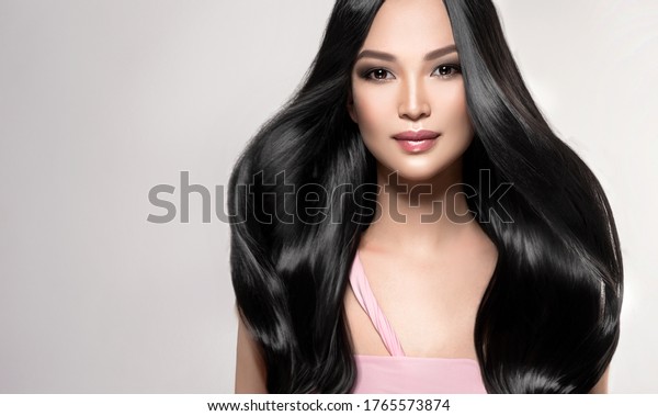 Beautiful asian model\
girl with shiny black and straight long hair . Keratin\
straightening . Treatment, care and spa procedures for hair .\
Chinese girl with smooth\
hairstyle