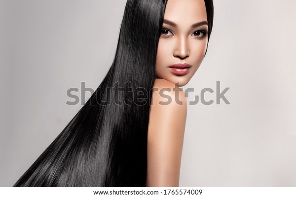 Beautiful asian model\
girl with shiny black and straight long hair . Keratin\
straightening . Treatment, care and spa procedures for hair .\
Chinese girl with smooth\
hairstyle