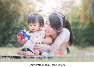 Beautiful Asian Mom And Baby Playing Toy  Happiness In The Park , Outdoor ,mother Day