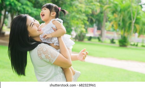 Beautiful Asian Mom And Baby Playing Happiness In The Park , Outdoor ,mother Day Concept