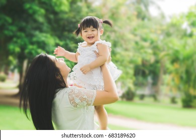 Beautiful Asian Mom And Baby Playing Happiness In The Park , Outdoor ,mother Day Concept