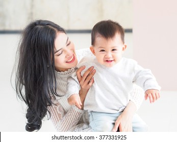 Beautiful Asian Mother And Son On Pastel Color Background.