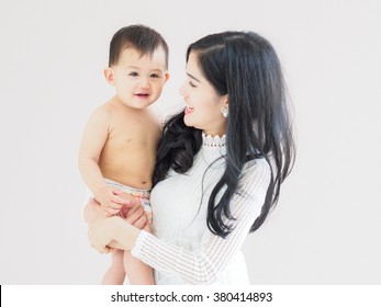 Beautiful Asian Mother And Son On Pastel Color Background.