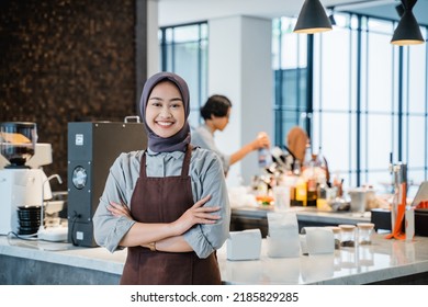 beautiful asian muslim woman crossed arm while standing in front of coffee shop - Powered by Shutterstock