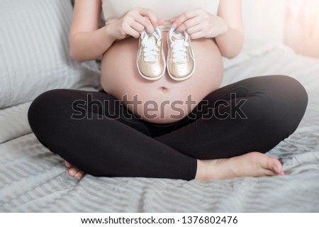 Similar – Pregnant woman embraced by her husband