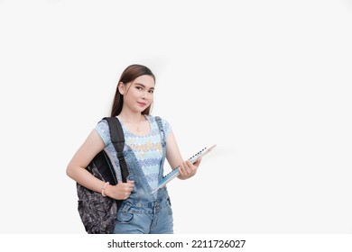 A Beautiful Asian School Girl Carrying A Backpack And Holding Folders Is Ready For Senior High School Life. Studio Shot Isolated White Background.