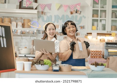 Beautiful asian sisters sell online bakery shop at home,family business,online influencer,start-up business.happyness Beautiful woman to take orders from customers,live-stream their sandwiches online - Powered by Shutterstock