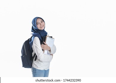 A Beautiful Asian Student In Hijab Standing And Holding A Laptop 