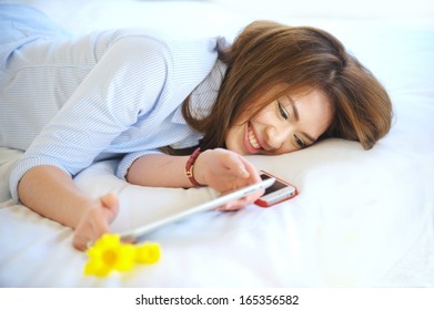 Beautiful Asian Teen Lay Down While Use Mobile Phone