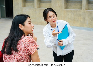 Beautiful Asian Tour Guide Staff Showing Giving Direction To Traveler Woman.