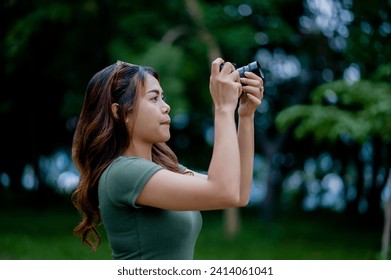 Beautiful Asian tourist and her personal camera female photographer Surround Milleles - Powered by Shutterstock