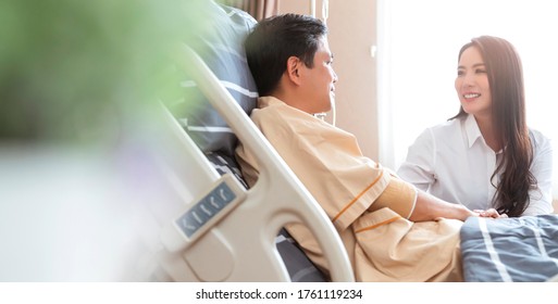 Beautiful Asian Wife Tending And Takecare Support To Asian Husband Patient Lying In Hospital Bed Ward Hospital Background