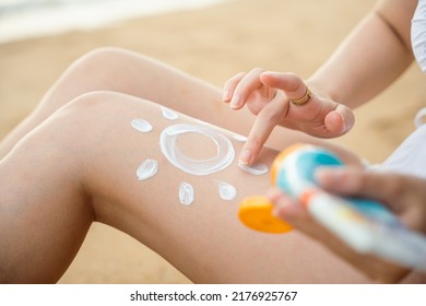 Beautiful Asian Woman Apply Sun Protection Cream On Tanned On Leg At Tropical Beach With White Sand, Sun Cream Skincare, Close Up Female In Bikini Using Sunscreen Lotion On Back Body Before Sunbathing